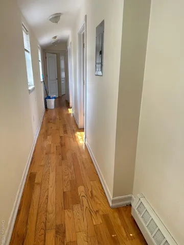 a view of a hallway with wooden floor