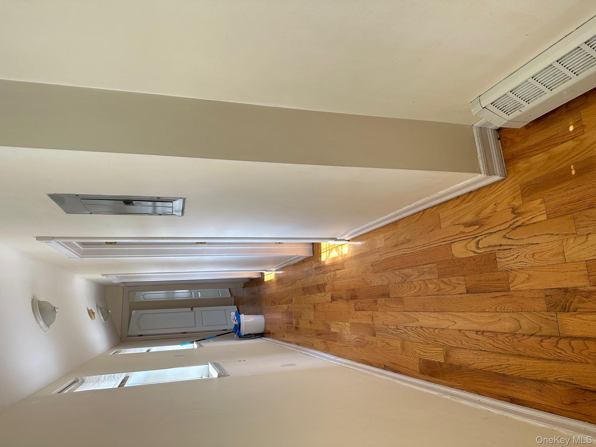 62-66 102nd Street Queens, NY 11374 - Photo 11 of 15 a view of a hallway with wooden floor