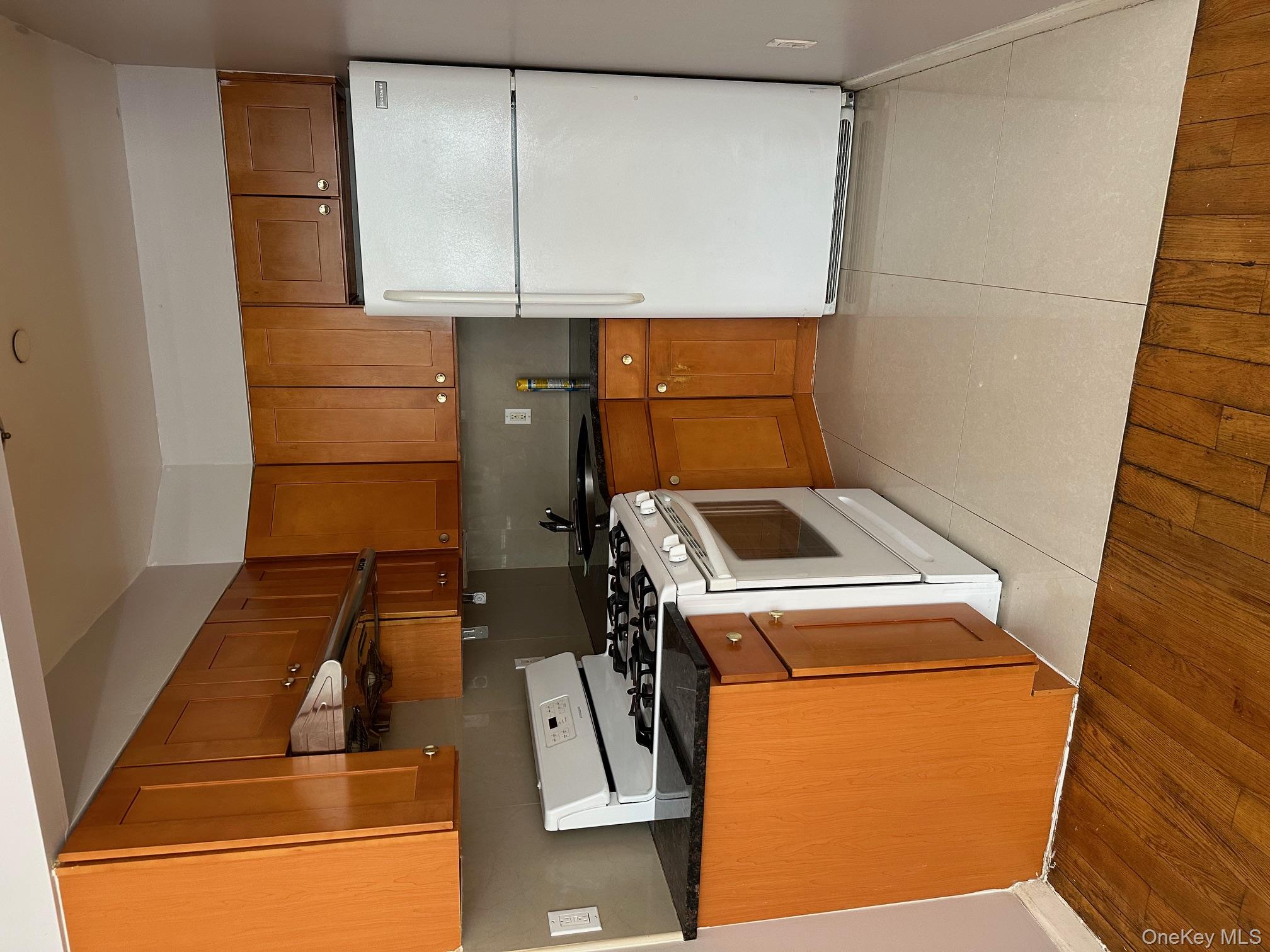 62-66 102nd Street Queens, NY 11374 - Photo 5 of 15 a kitchen with stainless steel appliances granite countertop a refrigerator a stove a sink and dishwasher