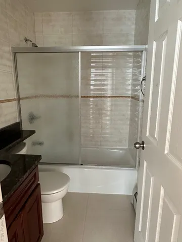 a bathroom with a shower a toilet and a sink