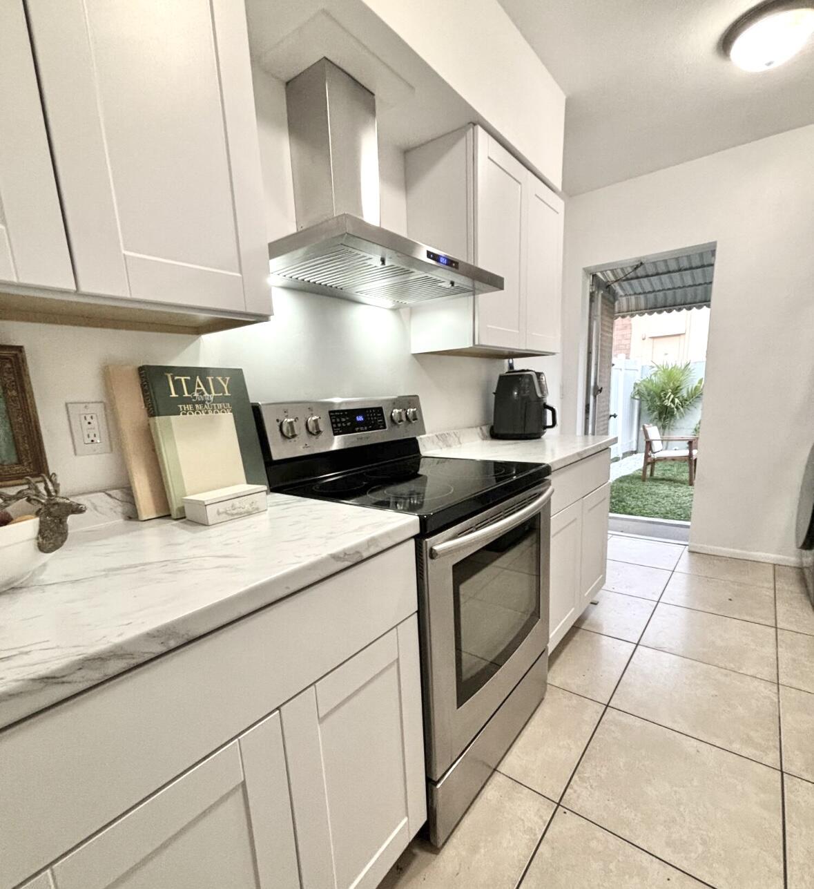 262 Southeast 9th Avenue, Unit C Deerfield Beach, FL 33441 - Photo 1 of 12 a kitchen with stainless steel appliances granite countertop a sink stove and cabinets