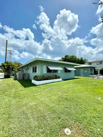 a front view of house with yard and lake