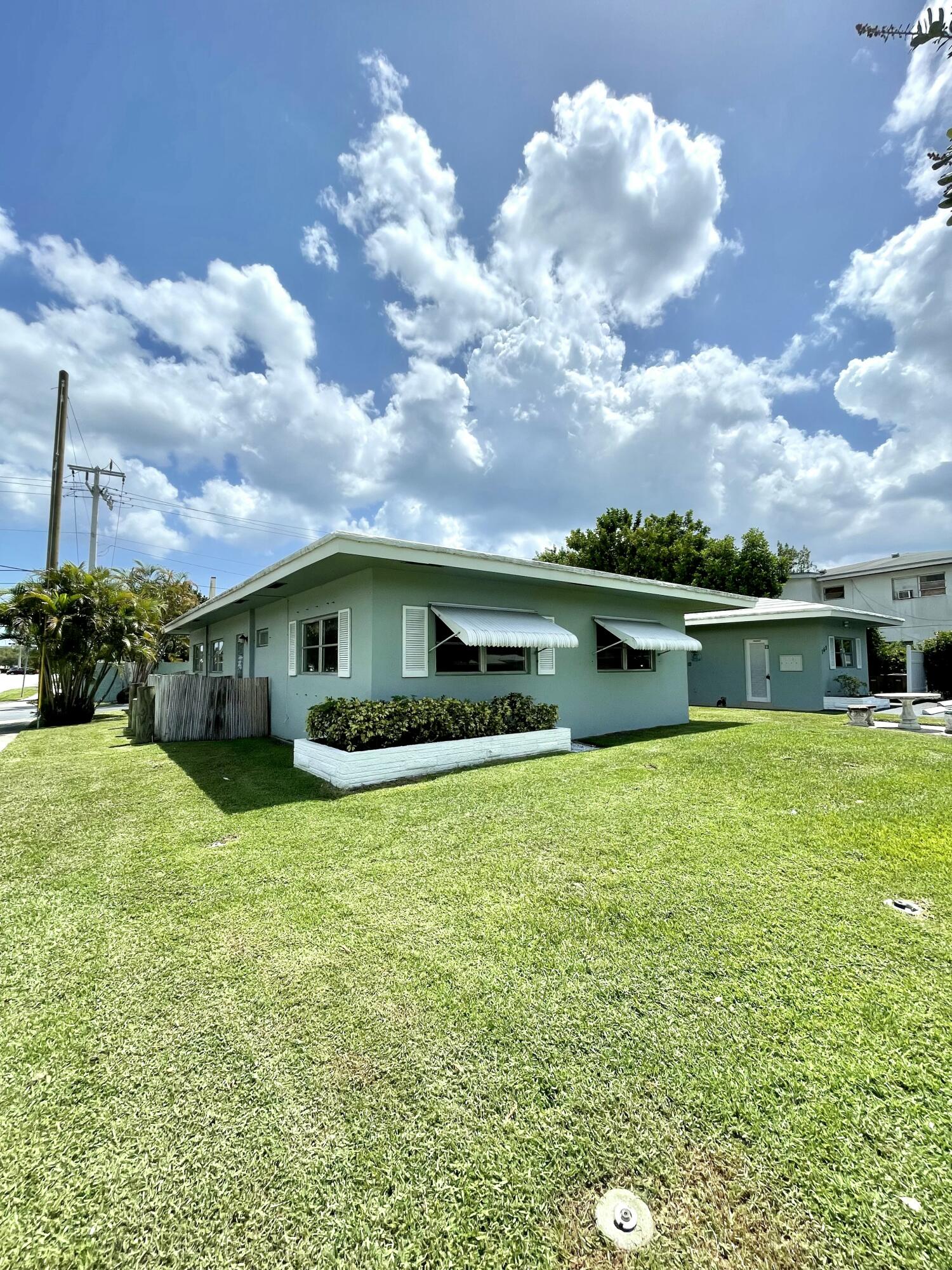 262 Southeast 9th Avenue, Unit C Deerfield Beach, FL 33441 - Photo 12 of 12 a front view of house with yard and lake