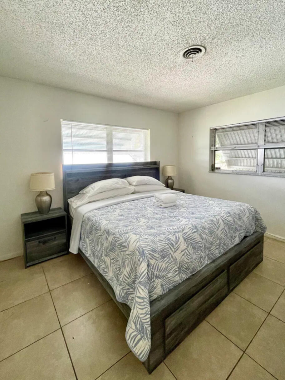 262 Southeast 9th Avenue, Unit C Deerfield Beach, FL 33441 - Photo 6 of 12 a bedroom with a bed and window