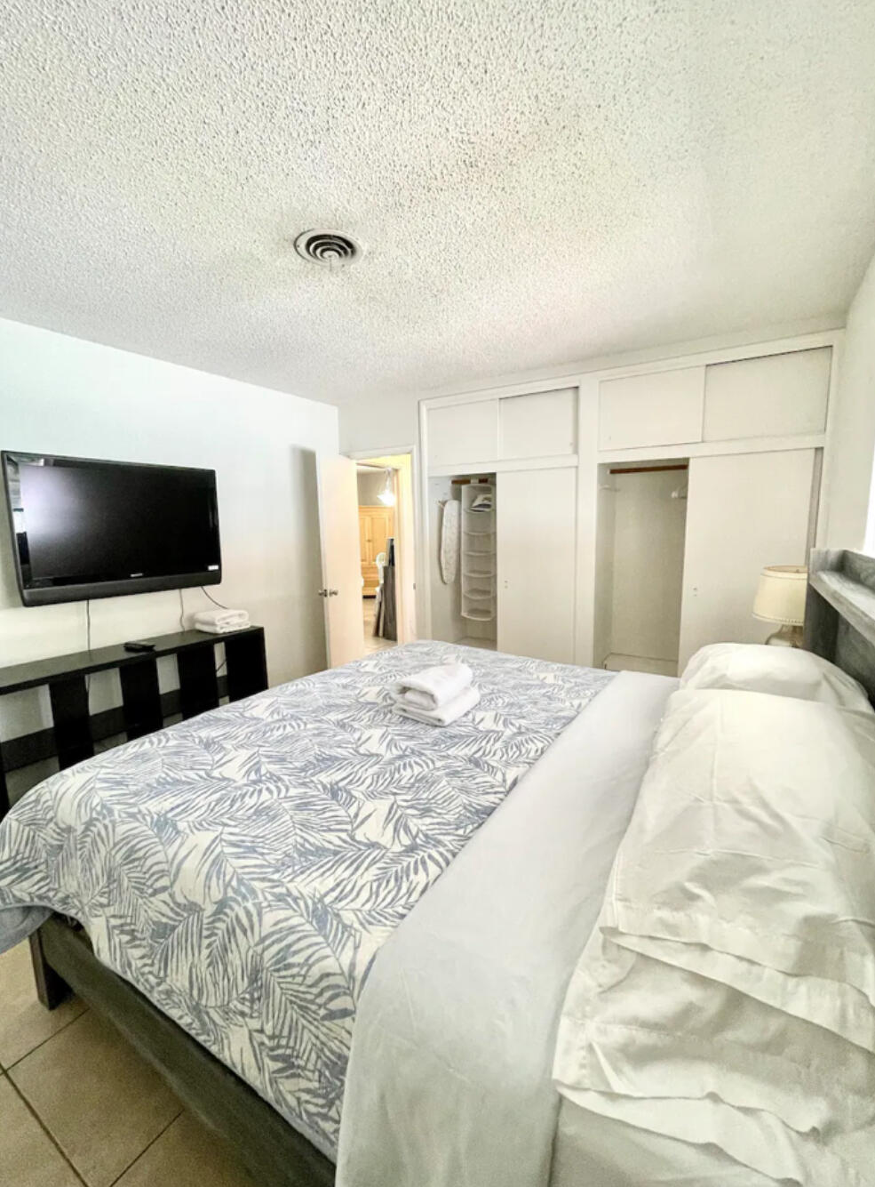 262 Southeast 9th Avenue, Unit C Deerfield Beach, FL 33441 - Photo 7 of 12 a bedroom with a bed and a flat screen tv