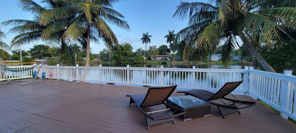 4154 Southwest 49th Street Dania Beach, FL 33314 - Photo 13 of 30 a view of a chair and tables on the roof deck