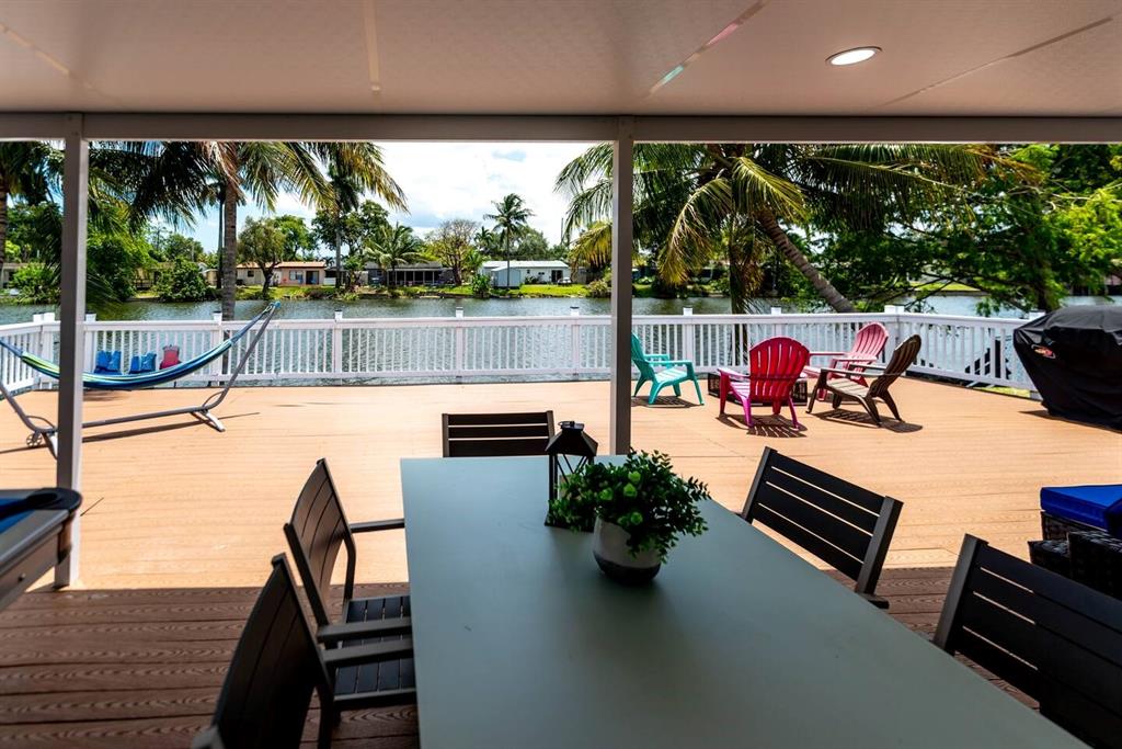 4154 Southwest 49th Street Dania Beach, FL 33314 - Photo 15 of 30 a living room with patio furniture and a floor to ceiling window
