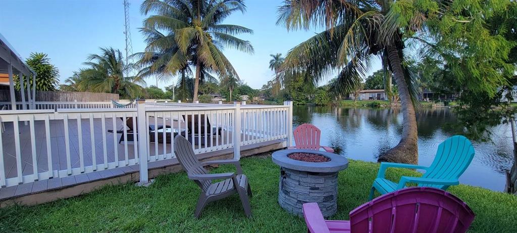 4154 Southwest 49th Street Dania Beach, FL 33314 - Photo 18 of 30 a view of a wooden dinning table and chairs in patio