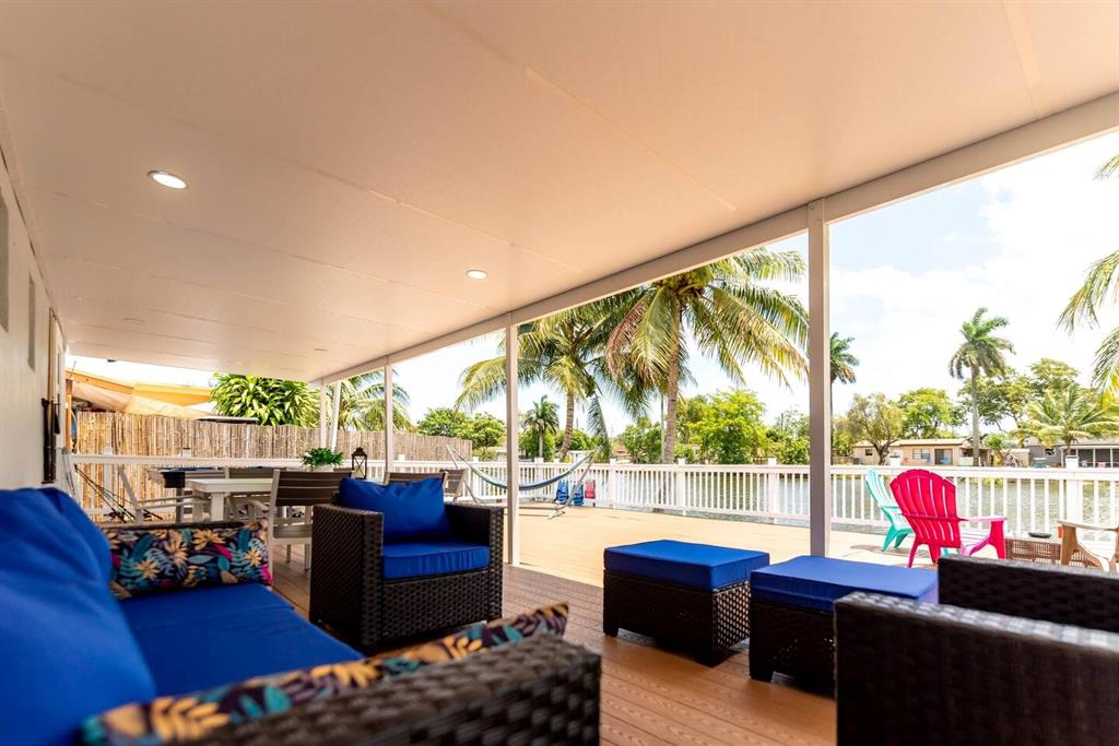 4154 Southwest 49th Street Dania Beach, FL 33314 - Photo 19 of 30 a living room with furniture and a floor to ceiling window