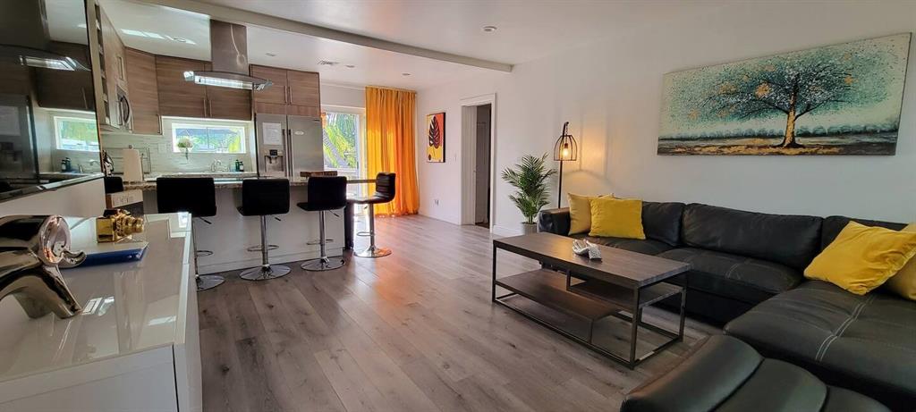 4154 Southwest 49th Street Dania Beach, FL 33314 - Photo 2 of 30 a living room with furniture and wooden floor