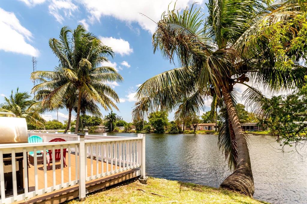4154 Southwest 49th Street Dania Beach, FL 33314 - Photo 22 of 30 a view of a swimming pool with a garden