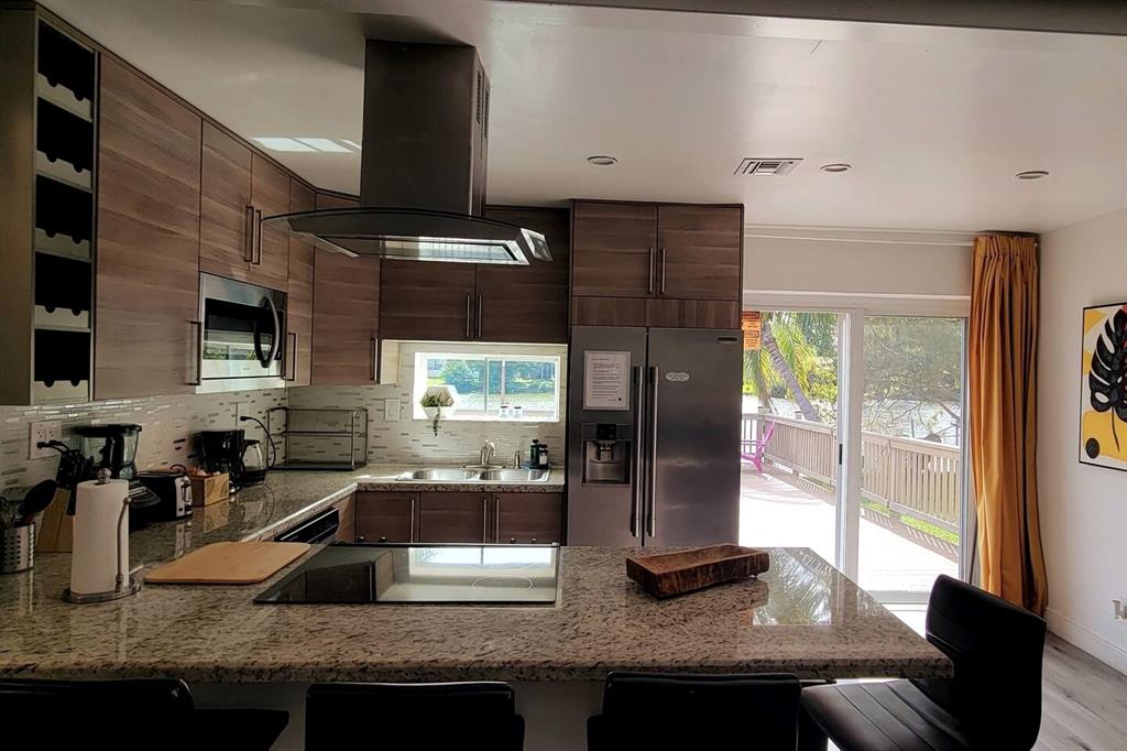 4154 Southwest 49th Street Dania Beach, FL 33314 - Photo 26 of 30 a kitchen with counter top space cabinets and a sink