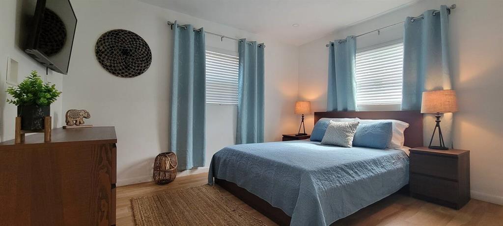 4154 Southwest 49th Street Dania Beach, FL 33314 - Photo 29 of 30 a bedroom with a bed and a potted plant