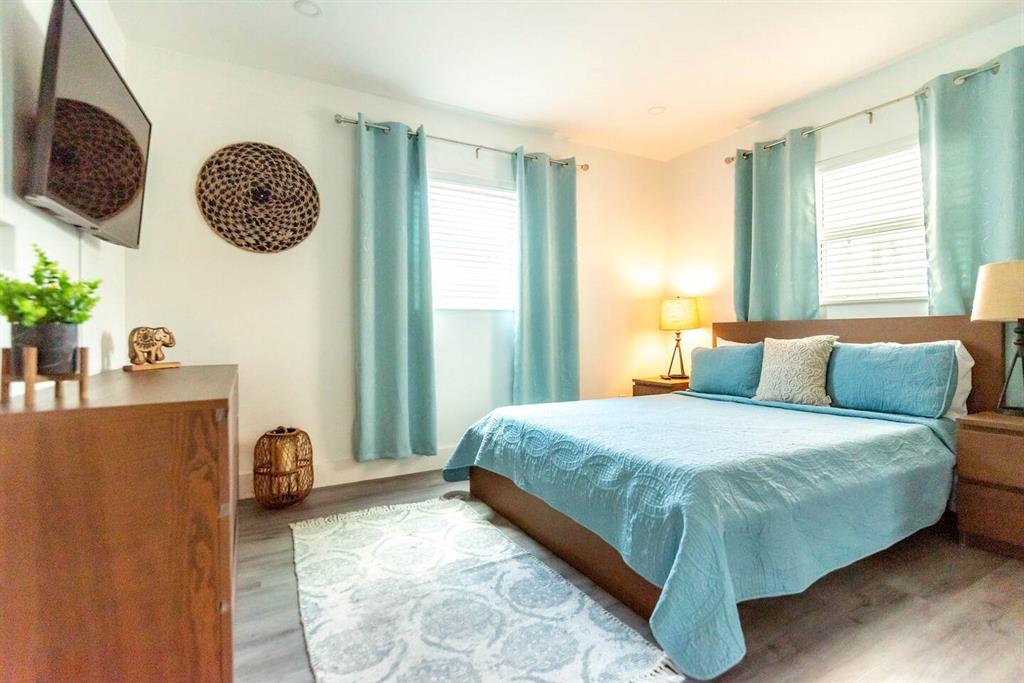 4154 Southwest 49th Street Dania Beach, FL 33314 - Photo 6 of 30 a bedroom with a bed mirror and window