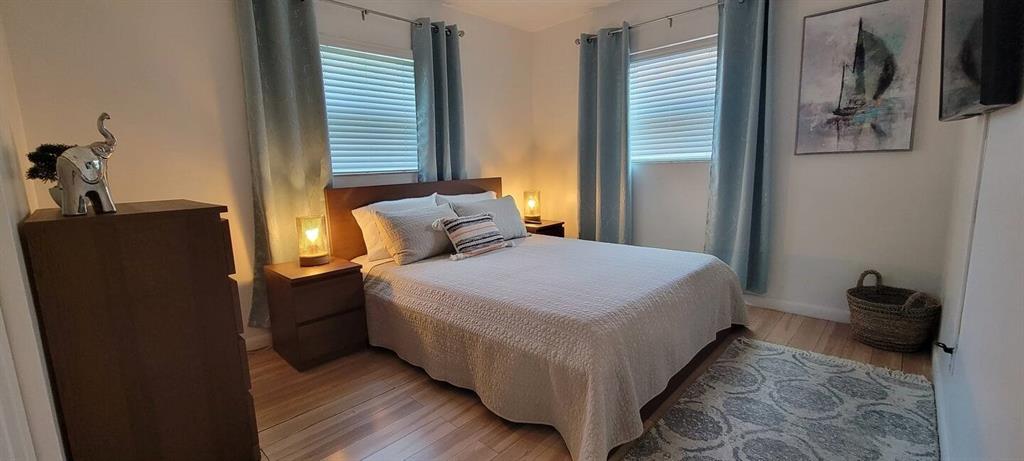 4154 Southwest 49th Street Dania Beach, FL 33314 - Photo 9 of 30 a bedroom with a bed and wooden floor