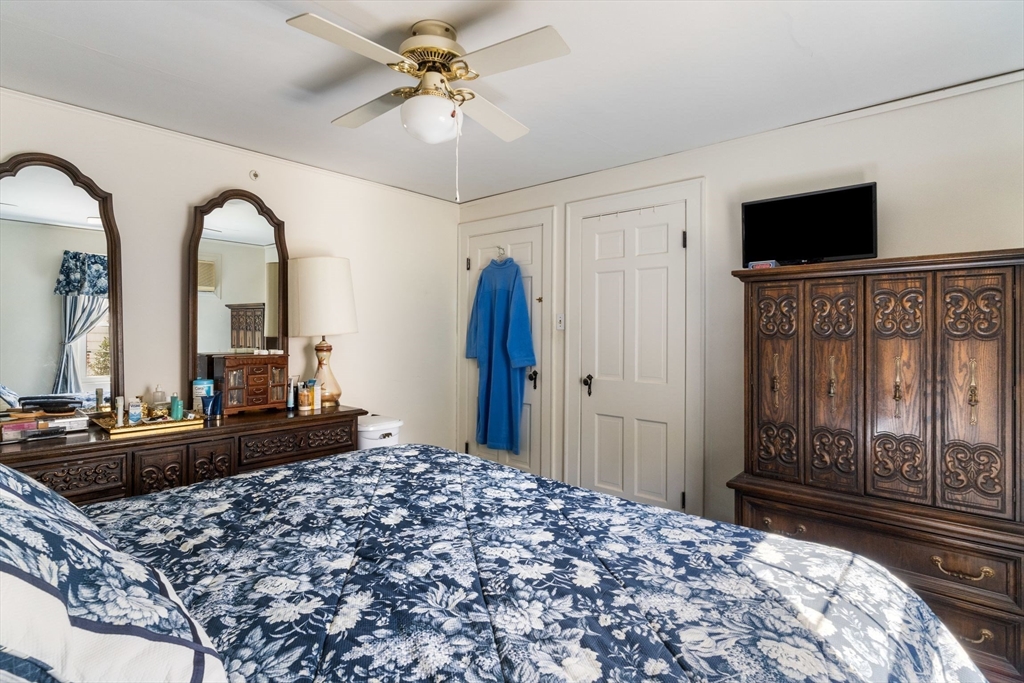 25 Centre Lane Milton, MA 02186 - Photo 15 of 32 a bedroom with a bed dresser and a flat tv screen