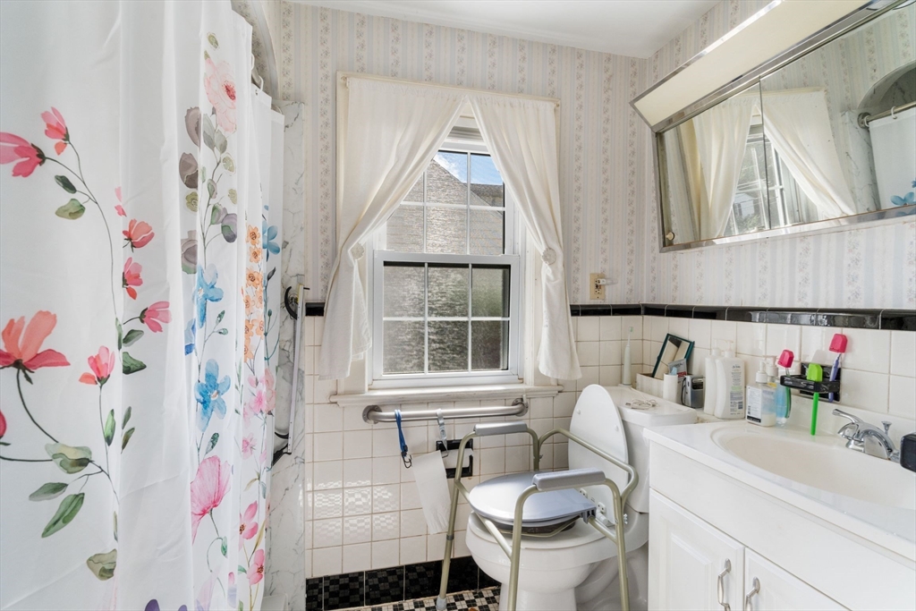 25 Centre Lane Milton, MA 02186 - Photo 16 of 32 a bathroom with a sink toilet and a mirror