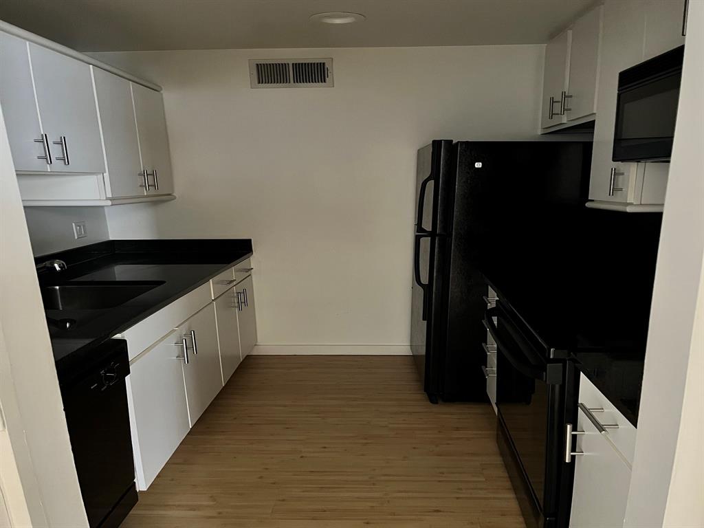 4343 Travis Street, Unit 10 Dallas, TX 75205 - Photo 6 of 10 a kitchen with a sink and a refrigerator