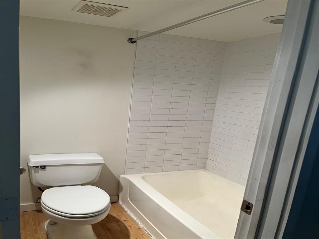4343 Travis Street, Unit 10 Dallas, TX 75205 - Photo 10 of 10 a white toilet sitting next to a bath tub