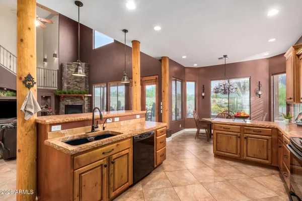 a spacious bedroom with a bed and a chandelier