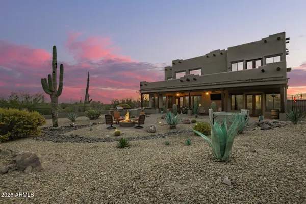 a view of a house with a backyard and sitting area