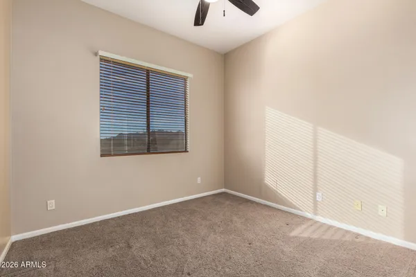 a bathroom with a granite countertop sink a mirror a vanity and shower