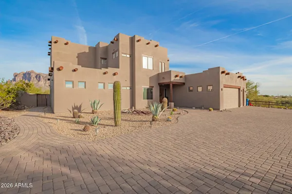 a view of a house with a yard and sitting area