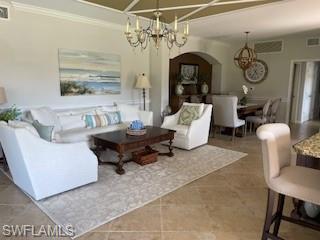a living room with furniture and a chandelier