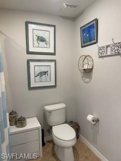 3149 Aviamar Circle, Unit 101 Naples, FL 34114 - Photo 14 of 20 a bathroom with a toilet a sink and a mirror