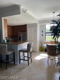 3149 Aviamar Circle, Unit 101 Naples, FL 34114 - Photo 3 of 20 a kitchen with a table chairs and a dining table