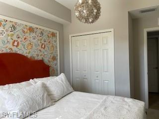 3149 Aviamar Circle, Unit 101 Naples, FL 34114 - Photo 10 of 20 a bedroom with a bed and a painting on the wall