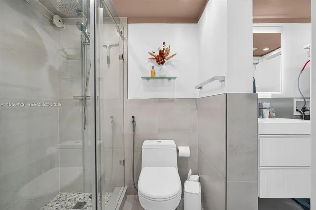 a white toilet sitting next to a bathroom sink