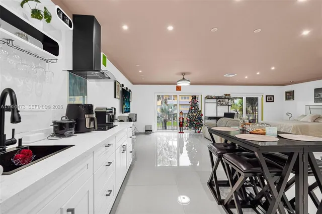 a kitchen with stainless steel appliances kitchen island granite countertop a sink and cabinets