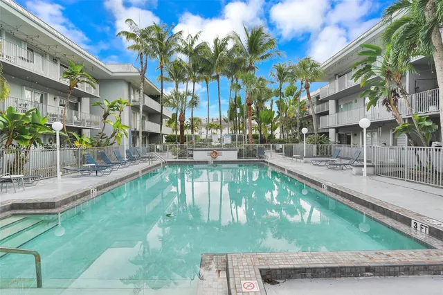 a swimming pool with outdoor seating and yard