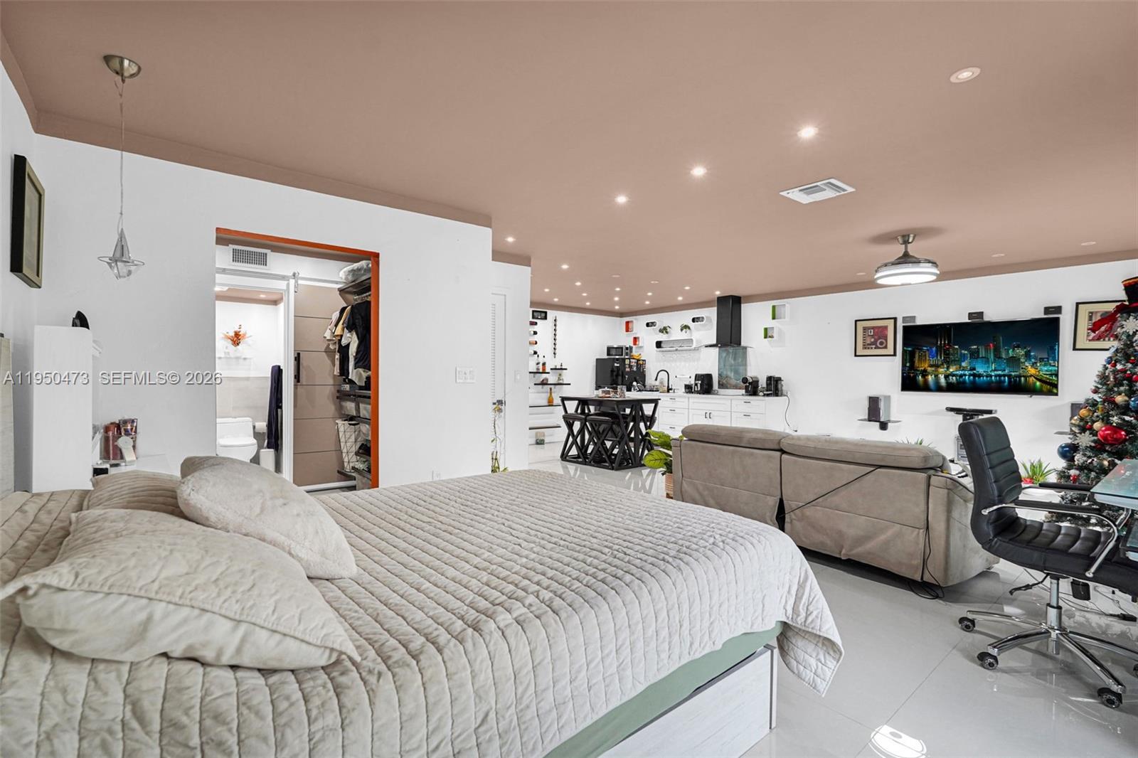 7401 Southwest 82nd Street, Unit 202S Miami, FL 33143 - Photo 30 of 39 a bedroom with furniture a bed and a flat screen tv