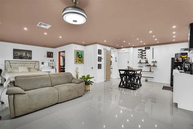 a living room with furniture and kitchen view