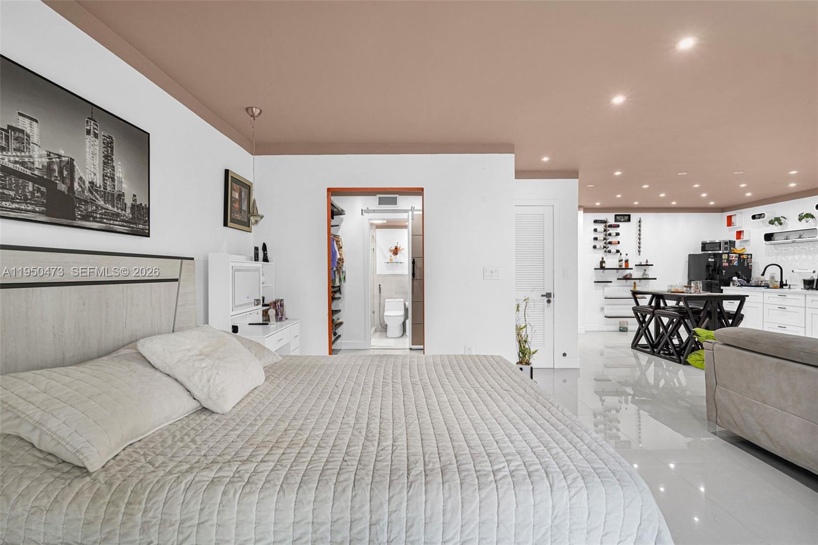 7401 Southwest 82nd Street, Unit 202S Miami, FL 33143 - Photo 31 of 39 a bedroom with a large bed and a couch