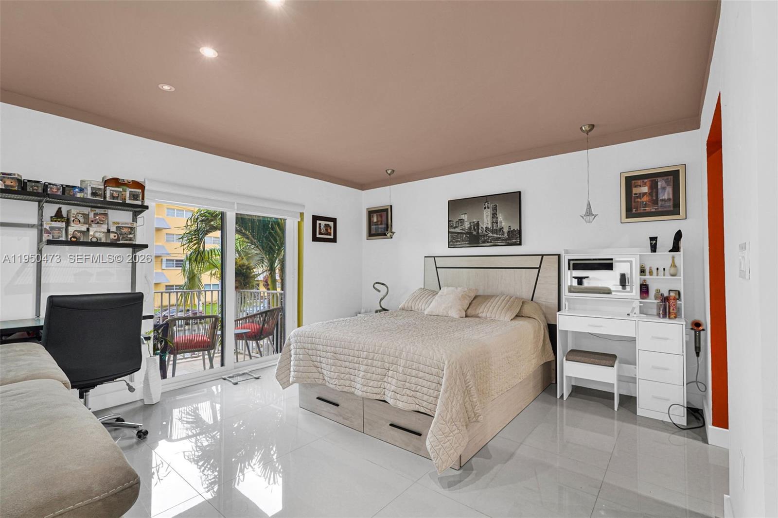 7401 Southwest 82nd Street, Unit 202S Miami, FL 33143 - Photo 32 of 39 a bedroom with a bed and furniture