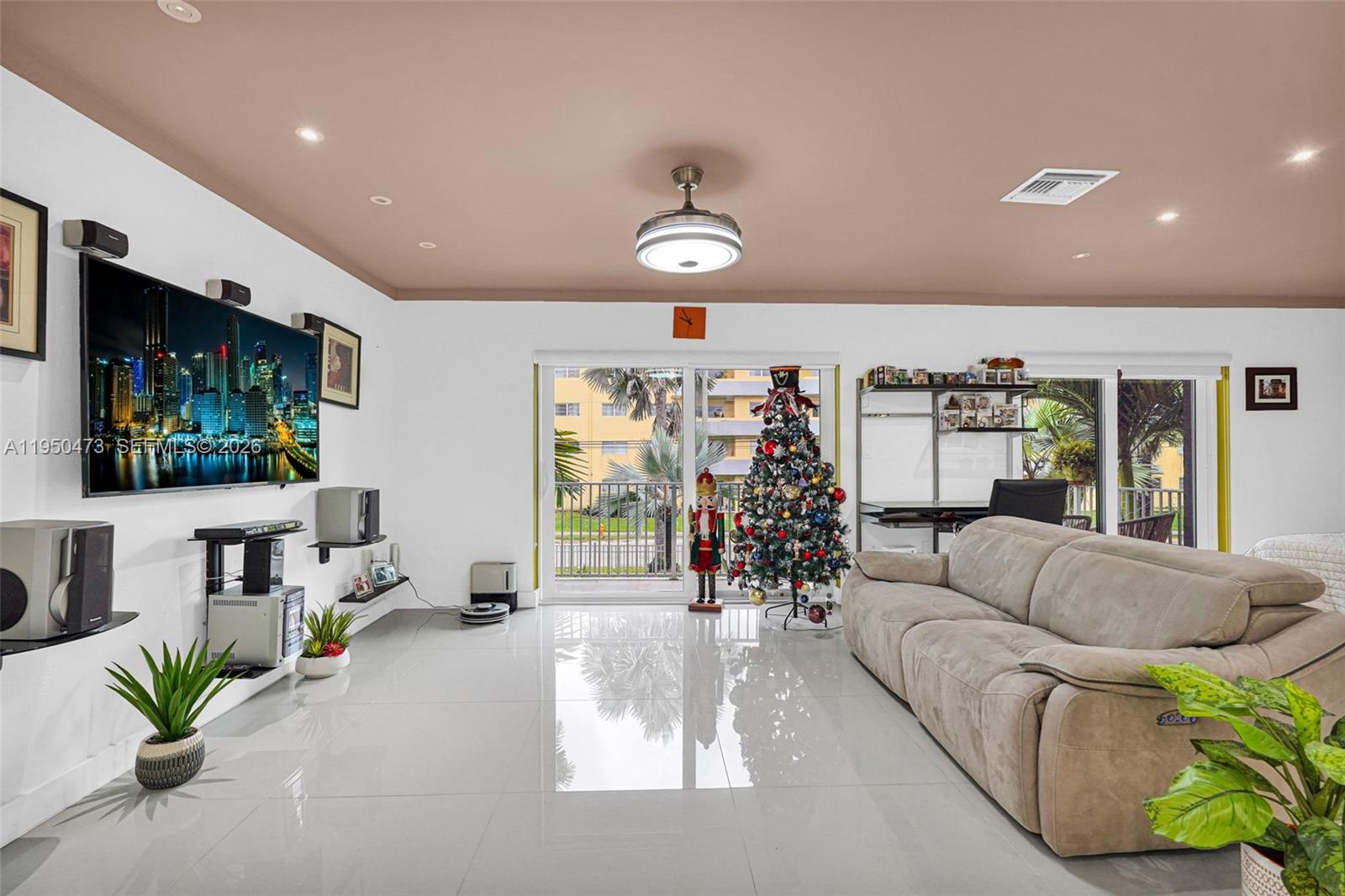7401 Southwest 82nd Street, Unit 202S Miami, FL 33143 - Photo 33 of 39 a living room with furniture and a flat screen tv