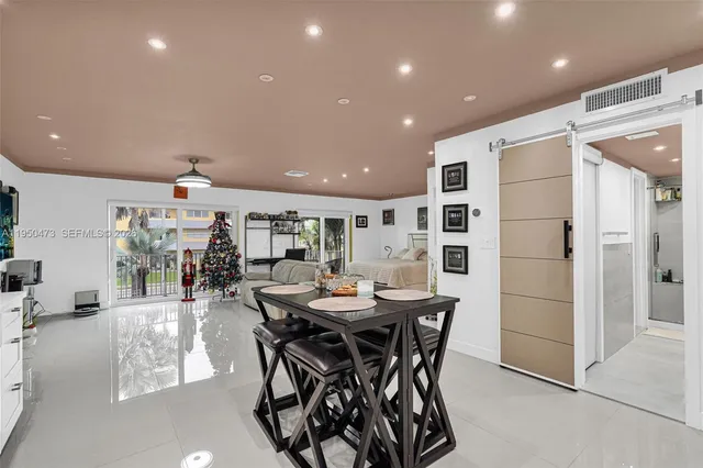 a bedroom with bed and a large window