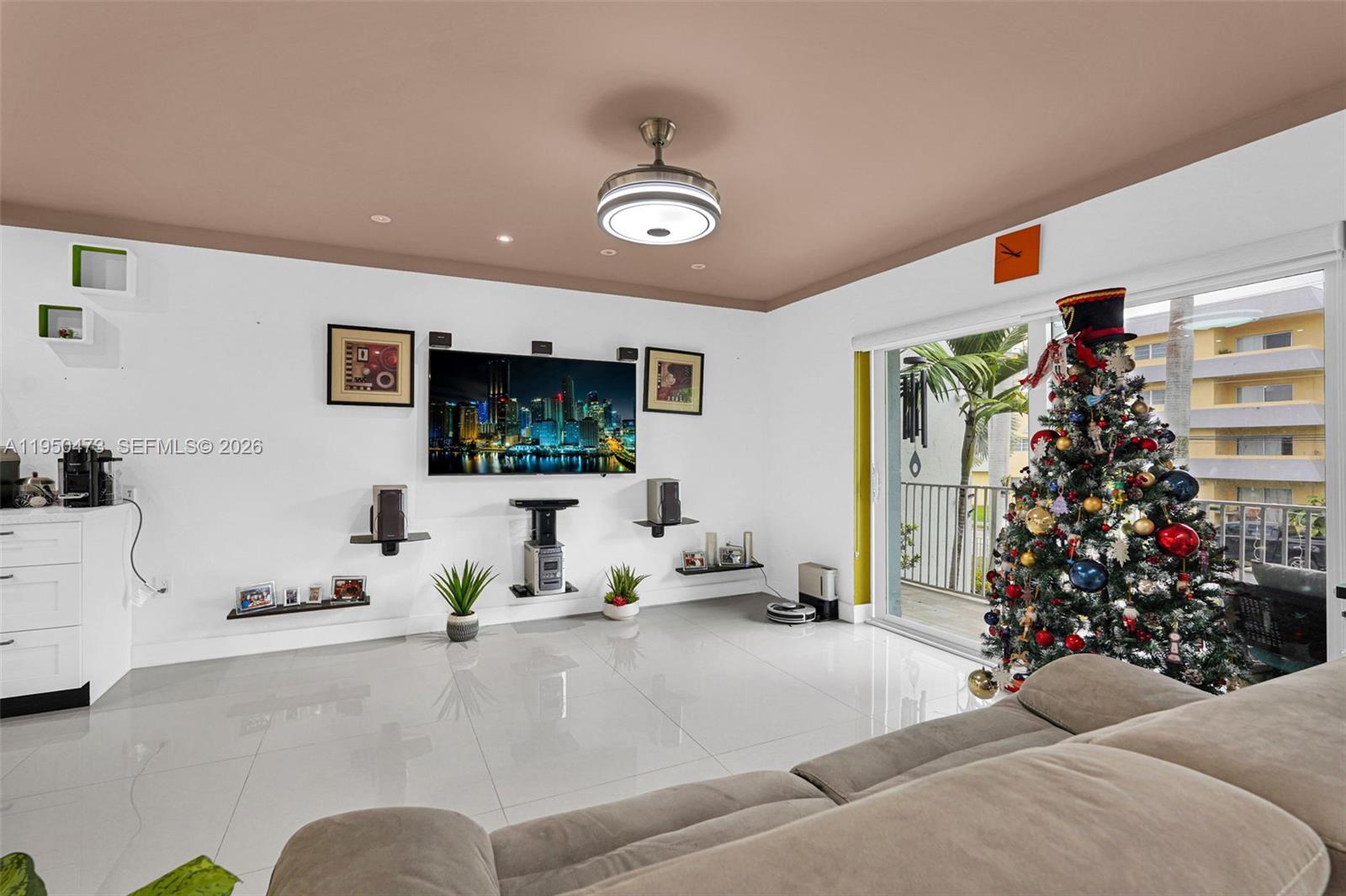 7401 Southwest 82nd Street, Unit 202S Miami, FL 33143 - Photo 38 of 39 a living room with furniture and a flat screen tv