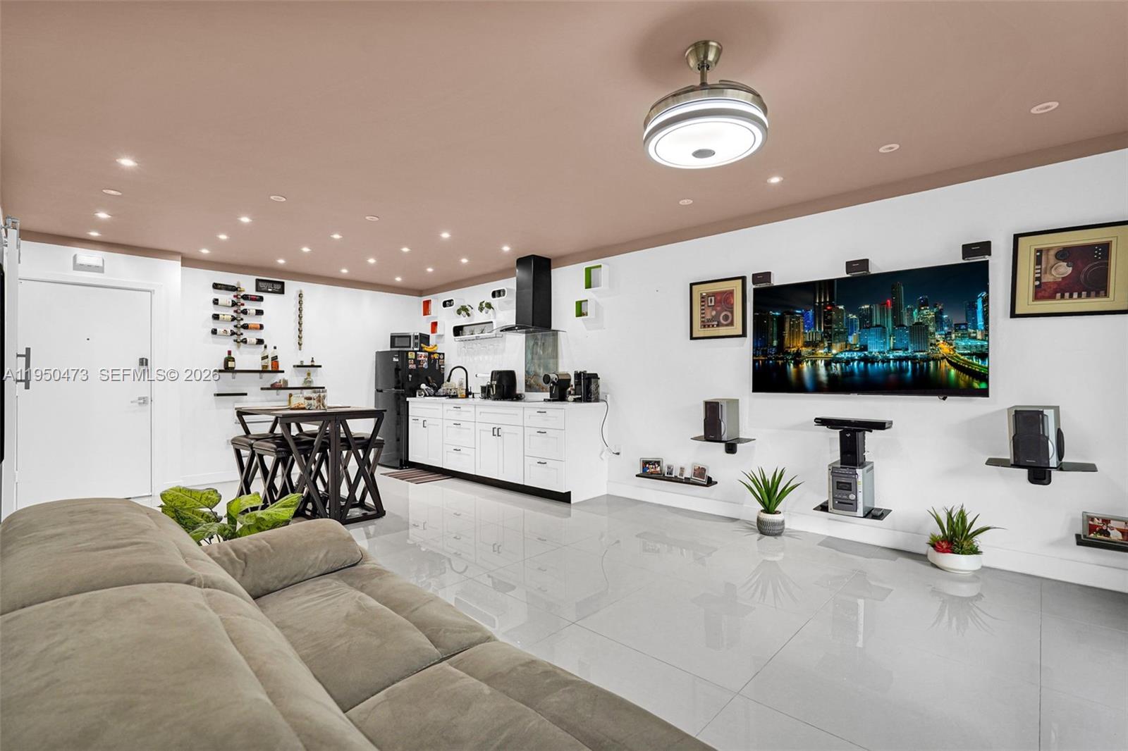 7401 Southwest 82nd Street, Unit 202S Miami, FL 33143 - Photo 39 of 39 a living room with furniture and a flat screen tv