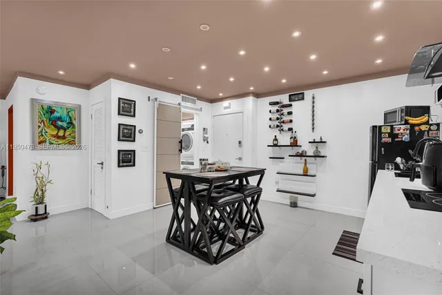 a kitchen with stainless steel appliances kitchen island granite countertop a table and chairs