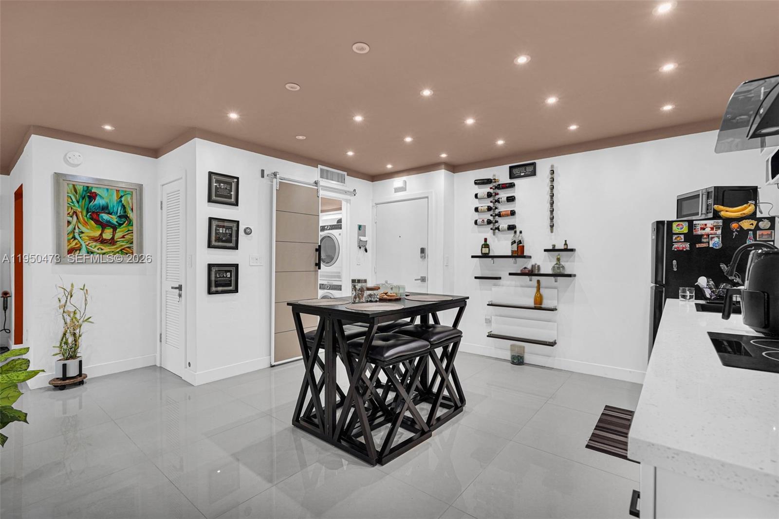 7401 Southwest 82nd Street, Unit 202S Miami, FL 33143 - Photo 4 of 39 a kitchen with stainless steel appliances kitchen island granite countertop a table and chairs