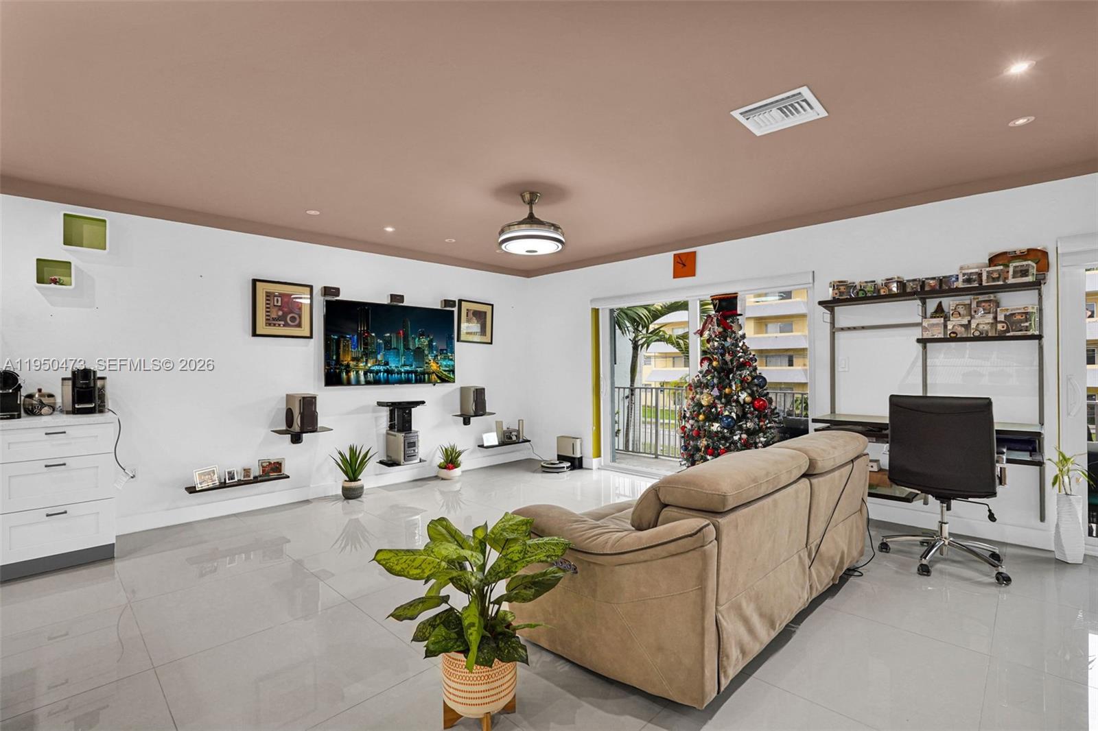 7401 Southwest 82nd Street, Unit 202S Miami, FL 33143 - Photo 5 of 39 a living room with furniture and a flat screen tv