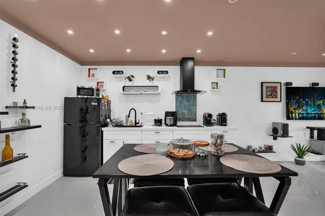a kitchen with refrigerator and cabinets