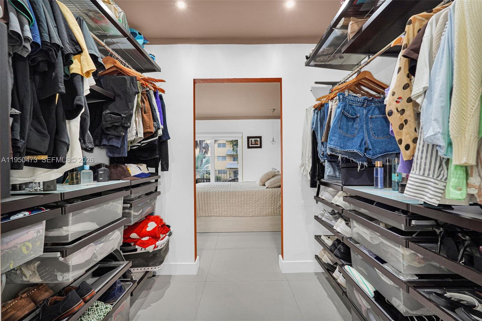 7401 Southwest 82nd Street, Unit 202S Miami, FL 33143 - Photo 10 of 39 a view of walk in closet with clothes and shoes