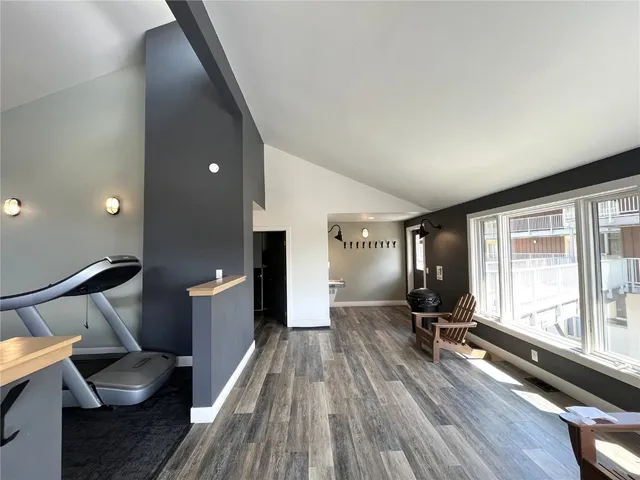 a view of a living room with furniture and wooden floor