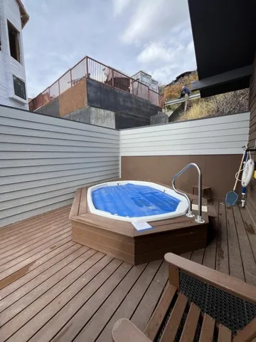 a balcony view with a table and chairs