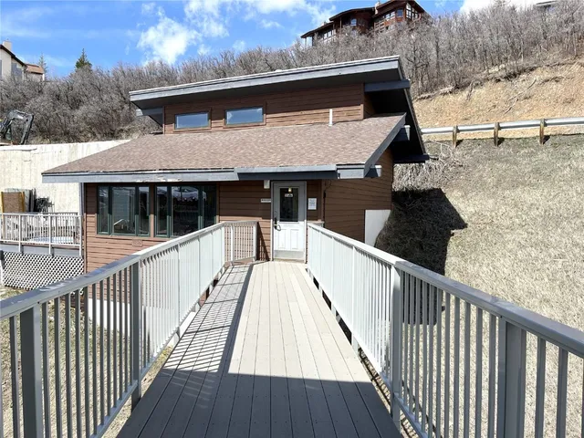 a view of a house with wooden deck